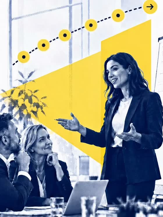 A seller mid-pitch, gesturing to two engaged buyers across a meeting-room table.